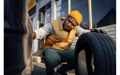 Service truck assisting a driver with a flat tire